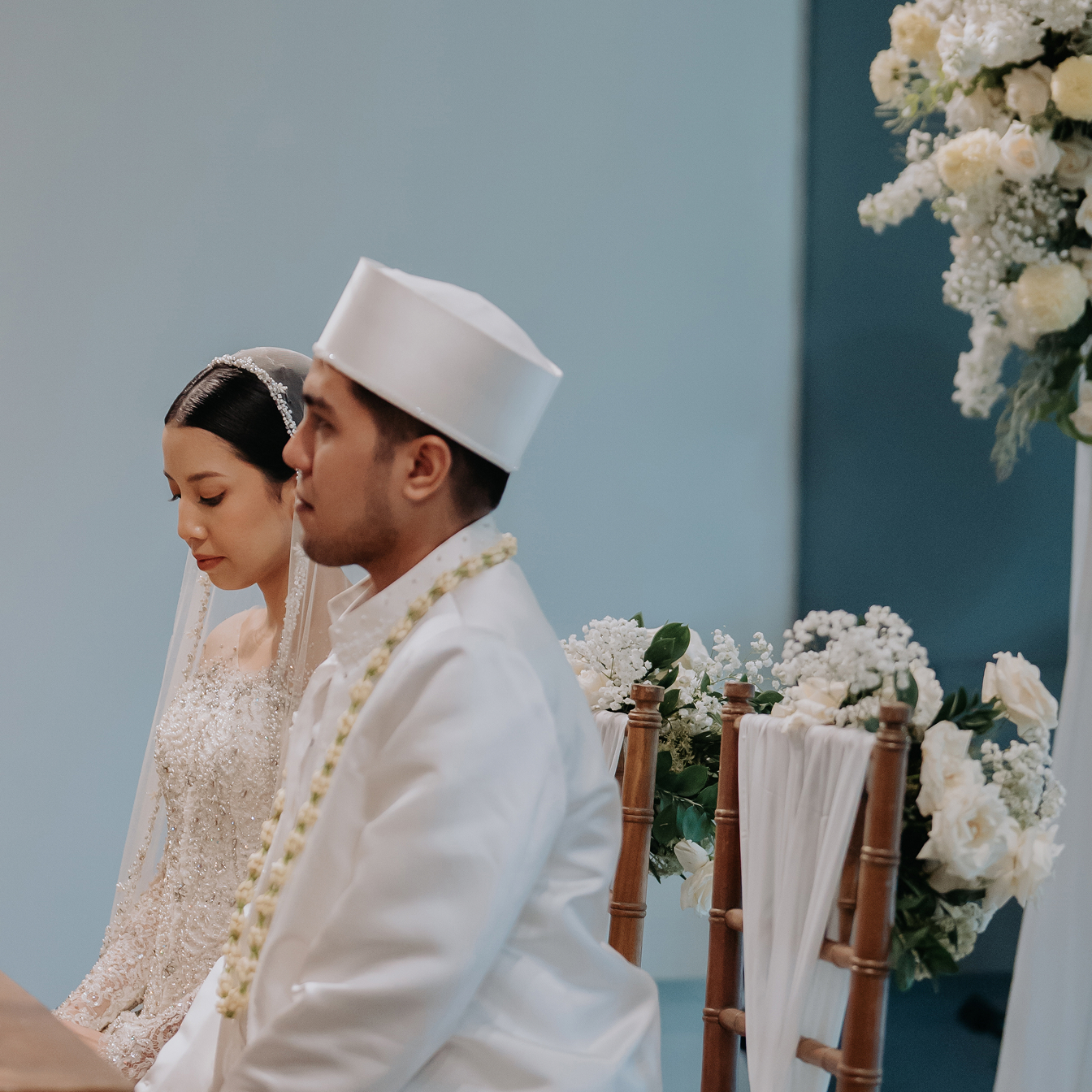 A bride and groom in traditional white wedding attire during an intimate ceremony at Titik Dua Ubud
